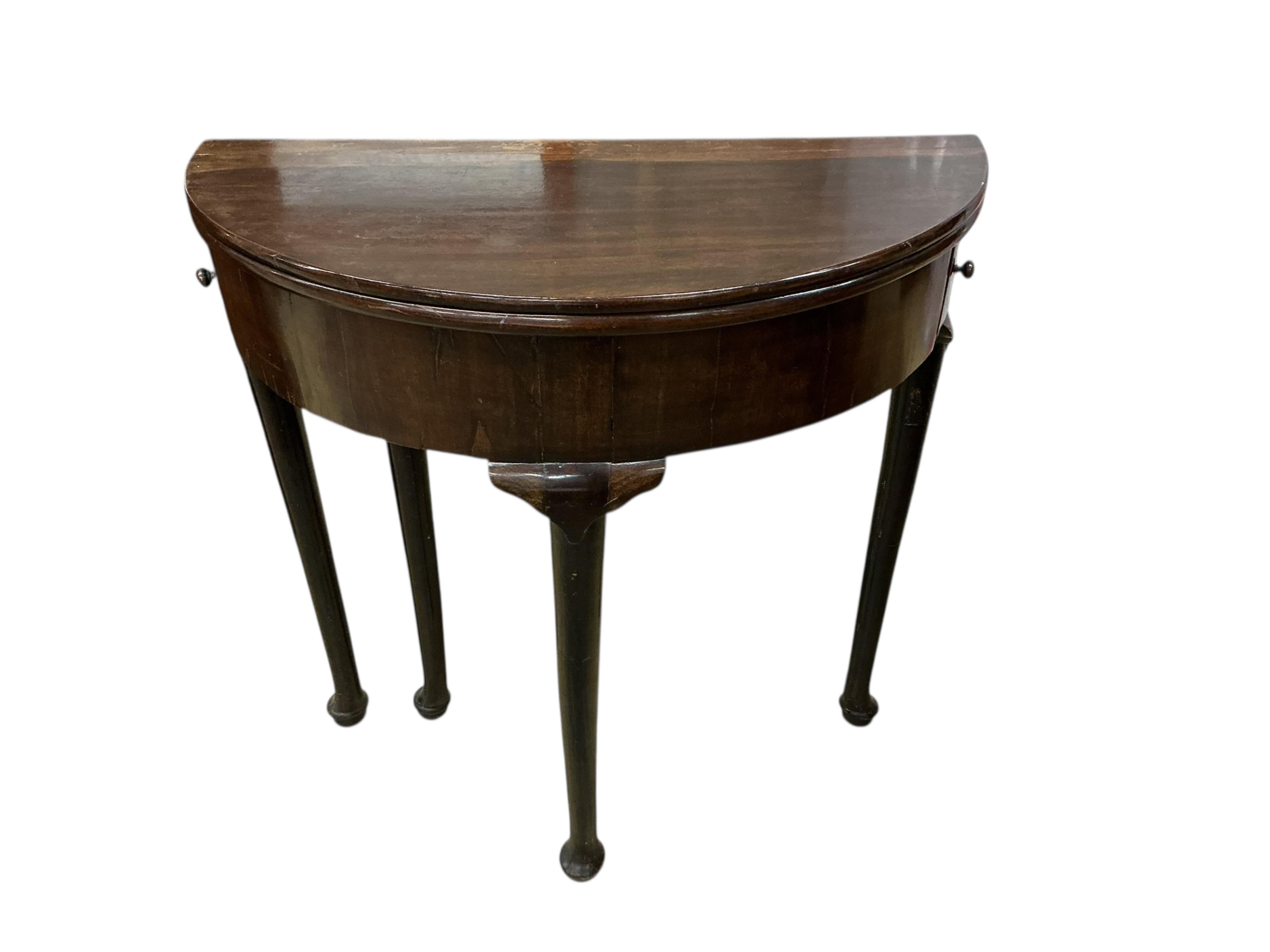 A George III mahogany demi-lune folding tea table, width 76cm, depth 37cm, height 73cm